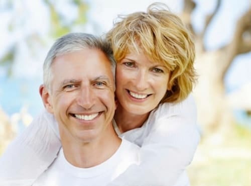 smiling older couple from dental implants renton washington